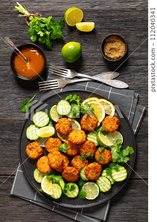 fried rice cutlets, rice tikki on black plate 112040341