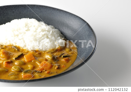 一張咖哩飯的照片,上面有大量蔬菜,如豬肉、南瓜和胡蘿蔔,白色背景 一張咖哩飯的照片,上面有大量蔬菜,如豬肉、南瓜和胡蘿蔔,白色背景 112042132