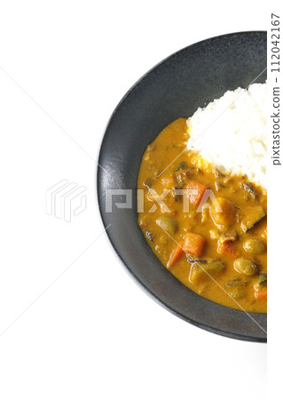 An overhead shot of curry rice with lots of vegetables such as pork, pumpkin, and carrots against a white background An overhead shot of curry rice with lots of vegetables such as pork, pumpkin, and carrots against a white background 112042167