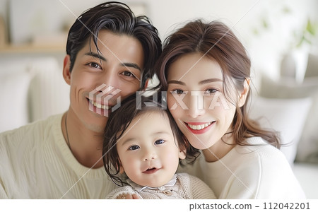 Family portrait of child-rearing generation looking at camera 112042201
