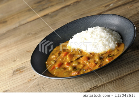 Curry rice with plenty of vegetables such as pork, pumpkin, and carrots. Curry rice with plenty of vegetables such as pork, pumpkin, and carrots. 112042615