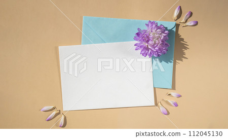 Composition with empty paper note and envelope beautiful spring blue flowers on beige background. Mockup card invitation greeting card postcard copy space template Composition with empty paper note and envelope beautiful spring blue flowers on beige background. Mockup card invitation greeting card postcard copy space template 112045130