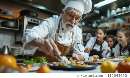 Master's skill: the chef instructs students in the art of cooking restaurant cuisine 112045630