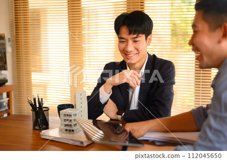 Two young architects working on new construction project in an office 112045650