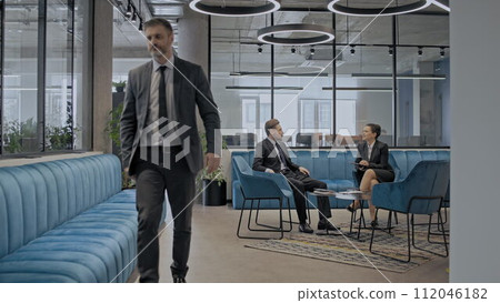 Business people communicating in large corporate office, company employees at work 112046182