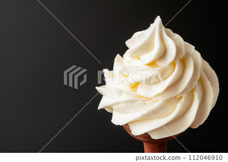 White texture of Vanilla ice cream with whipped cream on a stick on a black background. Detailed pure creamy background 112046910
