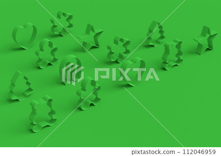 Set of metal cookie cutters for homemade Christmas biscuit on green monochrome 112046959