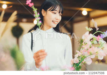 A female customer at a flower shop A female customer at a flower shop 112047506