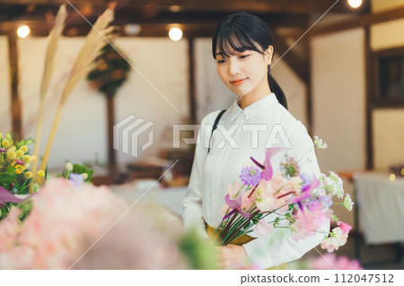 A female customer at a flower shop A female customer at a flower shop 112047512