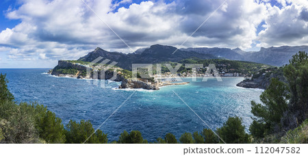 Expansive Coastal Panorama of Port de Soller with Cliffside Buildings, Mallorca Expansive Coastal Panorama of Port de Soller with Cliffside Buildings, Mallorca 112047582