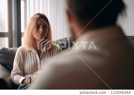 Contemplative Young Woman in One-on-One Meeting 112048368