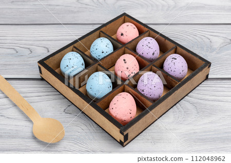 Colorful Easter eggs in a box on the wooden background 112048962
