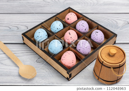 Colorful Easter eggs in a box on the wooden background 112048963