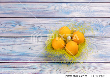 Easter eggs in a box on the wooden background. 112049062