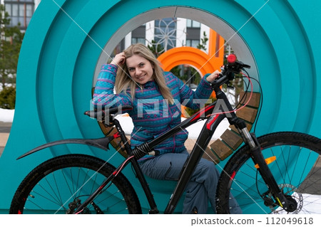 Pretty young woman took a break while walking 112049618