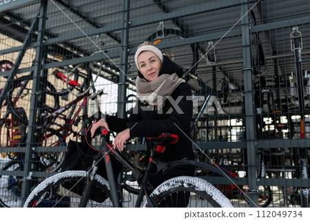 A young woman with blond dreadlocks walks through the city in winter A young woman with blond dreadlocks walks through the city in winter 112049734