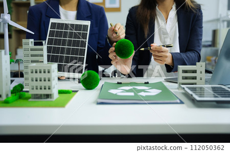 Businessman team using computer on CO2 emission reduction concept with global warming icon. along with climate, energy, sustainability, environment. Businessman team using computer on CO2 emission reduction concept with global warming icon. along with climate, energy, sustainability, environment. 112050362