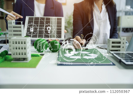 Businessman team using computer on CO2 emission reduction concept with global warming icon. along with climate, energy, sustainability, environment. Businessman team using computer on CO2 emission reduction concept with global warming icon. along with climate, energy, sustainability, environment. 112050367