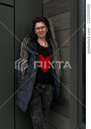 Lifestyle concept, young European woman with pigtails in her hair walking around the city 112050508