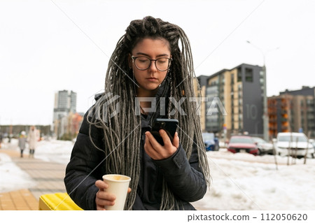 Photo on the street, young pretty informal woman wears dreadlocks hairstyle Photo on the street, young pretty informal woman wears dreadlocks hairstyle 112050620