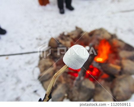 Marshmallow roasting at Aurora Village in Yellowknife, Canada in the harsh winter Marshmallow roasting at Aurora Village in Yellowknife, Canada in the harsh winter 112050911