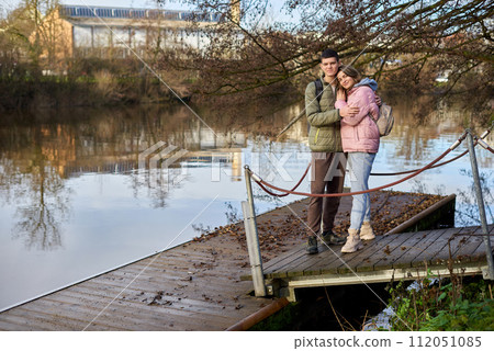 Embracing Moments: Beautiful 35-Year-Old Mother and 17-Year-Old Son in Winter or Autumn Park by Neckar River, Bietigheim-Bissingen, Germany Embracing Moments: Beautiful 35-Year-Old Mother and 17-Year-Old Son in Winter or Autumn Park by Neckar River, Bietigheim-Bissingen, Germany 112051085