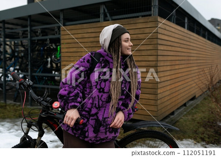 Cute young woman riding a bicycle Cute young woman riding a bicycle 112051191