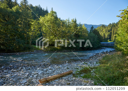 Alpine Oasis: A Mountain River's Journey through Rocky Shores and Forests. Alpine River, Rocky Shores, and Towering Forests. Nature, Mountain River, Spruce Forests, and Alpine Wilderness. Eco 112051209
