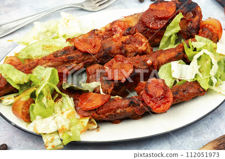 Stewed pork ribs in sauce. 112051973