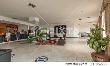 Panorama showing Interior of lobby hotel reception in daytime timelapse. 112052212