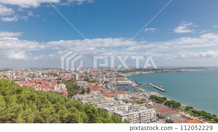Panorama showing aerial view of marina and city center timelapse in Setubal, Portugal. 112052229