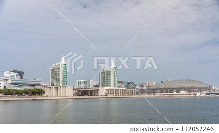 Modern tall residential and office buildings reflecting in the water timelapse hyperlapse in Lisbon, Portugal. 112052246