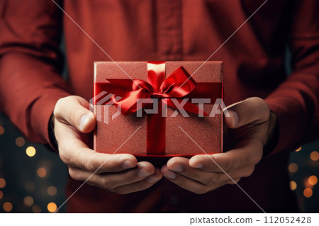 man in shirt holding gift cardboard box with red bow 112052428