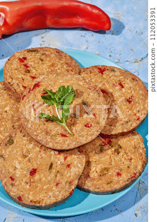 sliced vegan roll on a blue plate 112053391