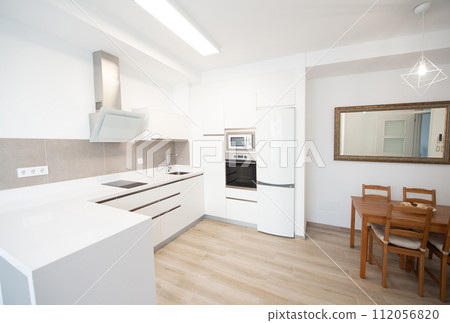 modern kitchen in a home equipped with appliances and decoration 112056820