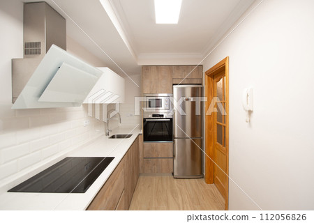 modern kitchen in a home equipped with appliances and decoration 112056826