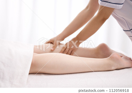 A woman receiving a foot massage from an esthetician A woman receiving a foot massage from an esthetician 112056918