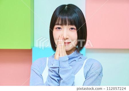 Colorful background with young woman in prayer pose 112057224