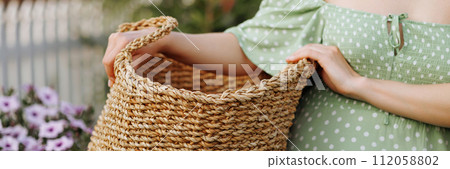 Banner caucasian woman holding a large woven basket. Banner caucasian woman holding a large woven basket. 112058802