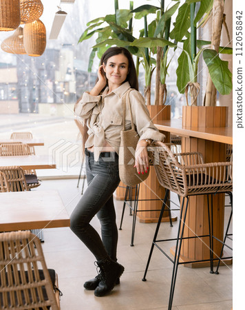 Attractive woman in hipster cafe and looking at camera 112058842