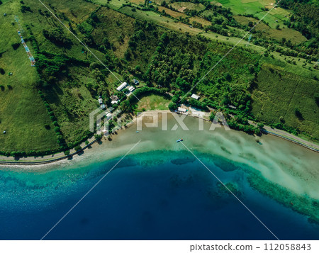 Aerial view of blue ocean coastline with road in Sumbawa Aerial view of blue ocean coastline with road in Sumbawa 112058843