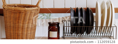 Banner wicker basket, jar, dish rack with plates in kitcen 112059128