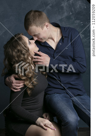 Portrait of a beautiful couple in love on a dark background. Portrait of a beautiful couple in love on a dark background. 112059209