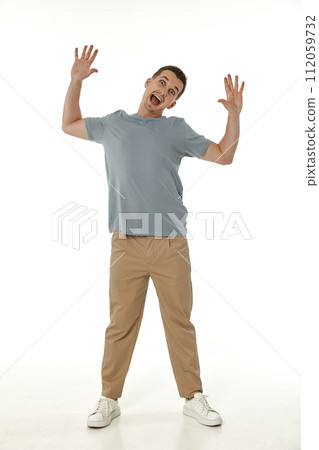 surprised guy looking at camera on white studio background surprised guy looking at camera on white studio background 112059732