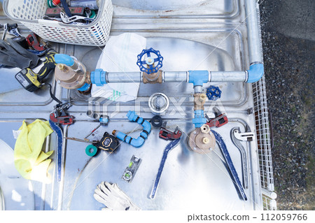 Water supply pipe repair work around the water tank 112059766