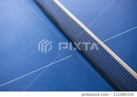Closeup of net on blue table for ping-pong. The concept of sport and healthy lifestyle. Table tennis 112060326
