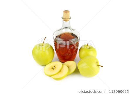 Apple cider in a vintage bottle and fresh apples isolated on a white. 112060655