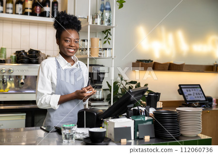Woman waiter taking customer orders writing details in paper notebook 112060736