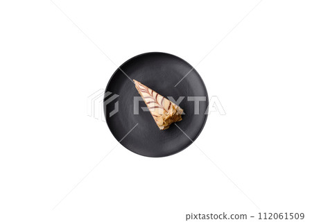 Piece of delicious sweet esterhazy cake with nuts and cream 112061509