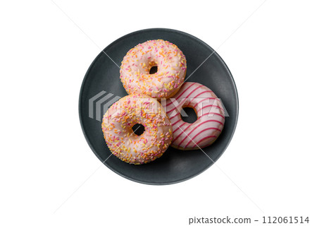 Delicious sweet bright donuts with cream on a plain background 112061514